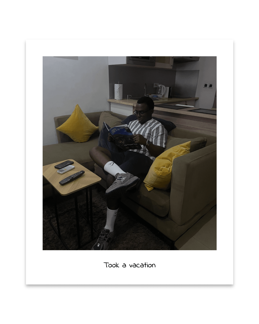Pelumi reading on a sofa while on vacation